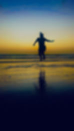 Girl jumping on the beach