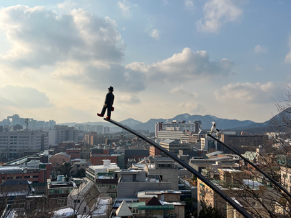 View of Seoul city with a miniature statue walking