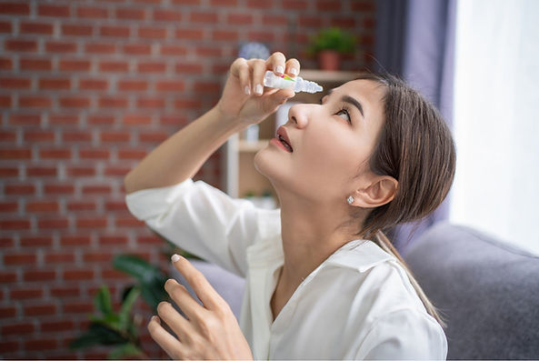Woman applying eye drops for dry eye treatment in Daly City
