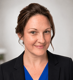 Lynn Ann Blix FNP-BC - Smiling woman with brown hair in a black blazer and blue top