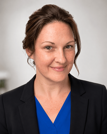 Lynn Ann Blix FNP-BC - Portrait of a smiling woman in a dark blazer and blue top.