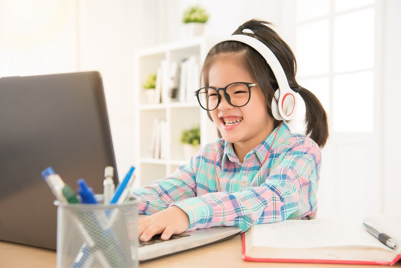 Child with glasses using laptop, Eye Doctor in Daly City