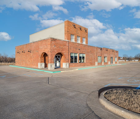 Red brick commercial building under a blue sky