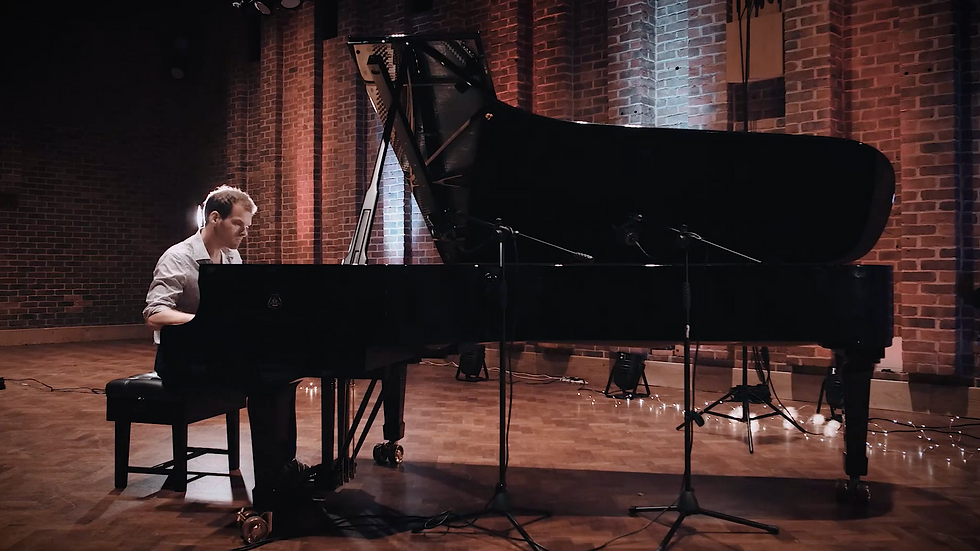 Eye-level view of a jazz quartet performing on stage with saxophone and piano