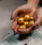 Hands holding golden mushroom chocolate candies – Collectif Mind microdosing product