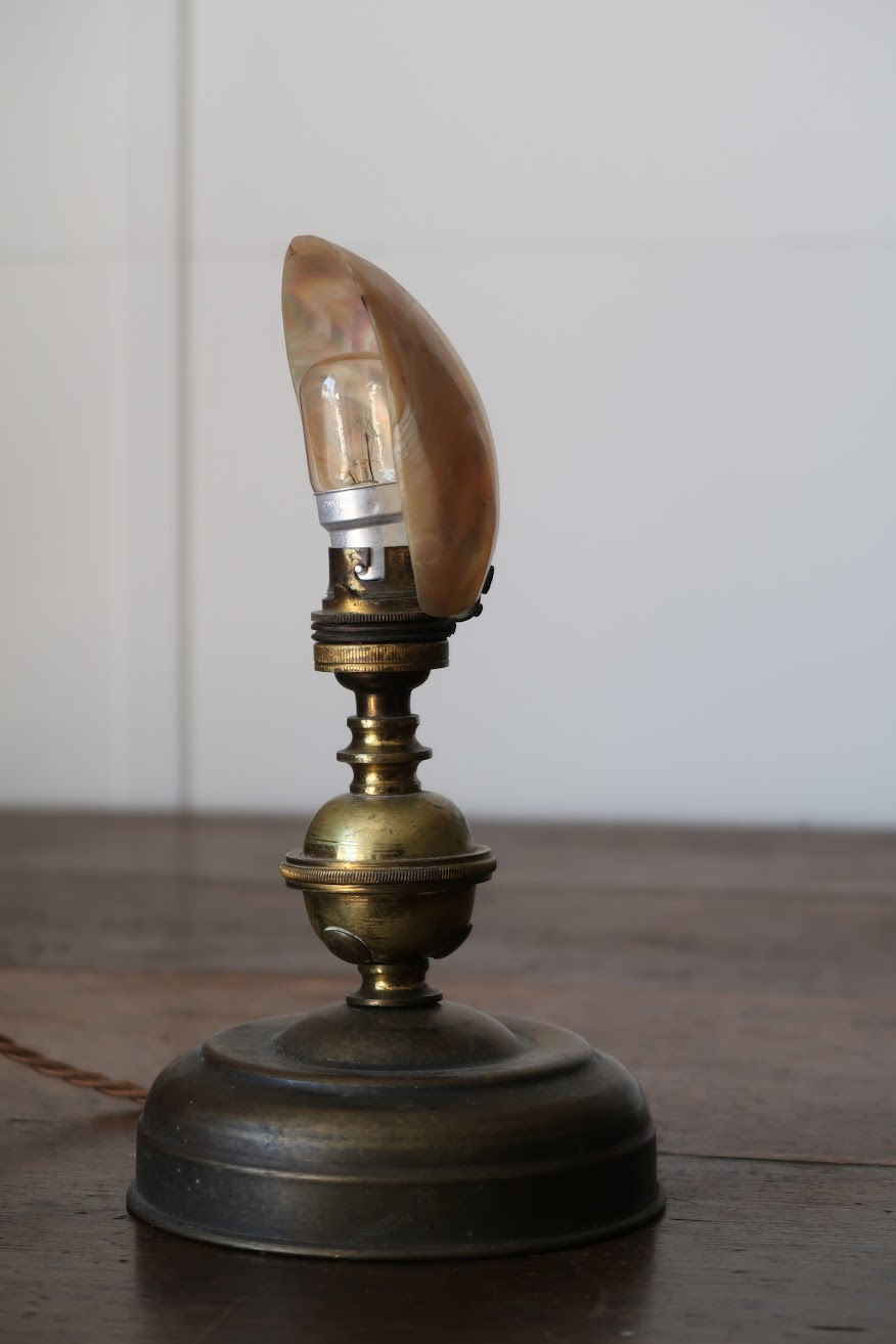 Thumbnail: An early 20th century brass table lamp with mother of pearl shade, circa 1900
