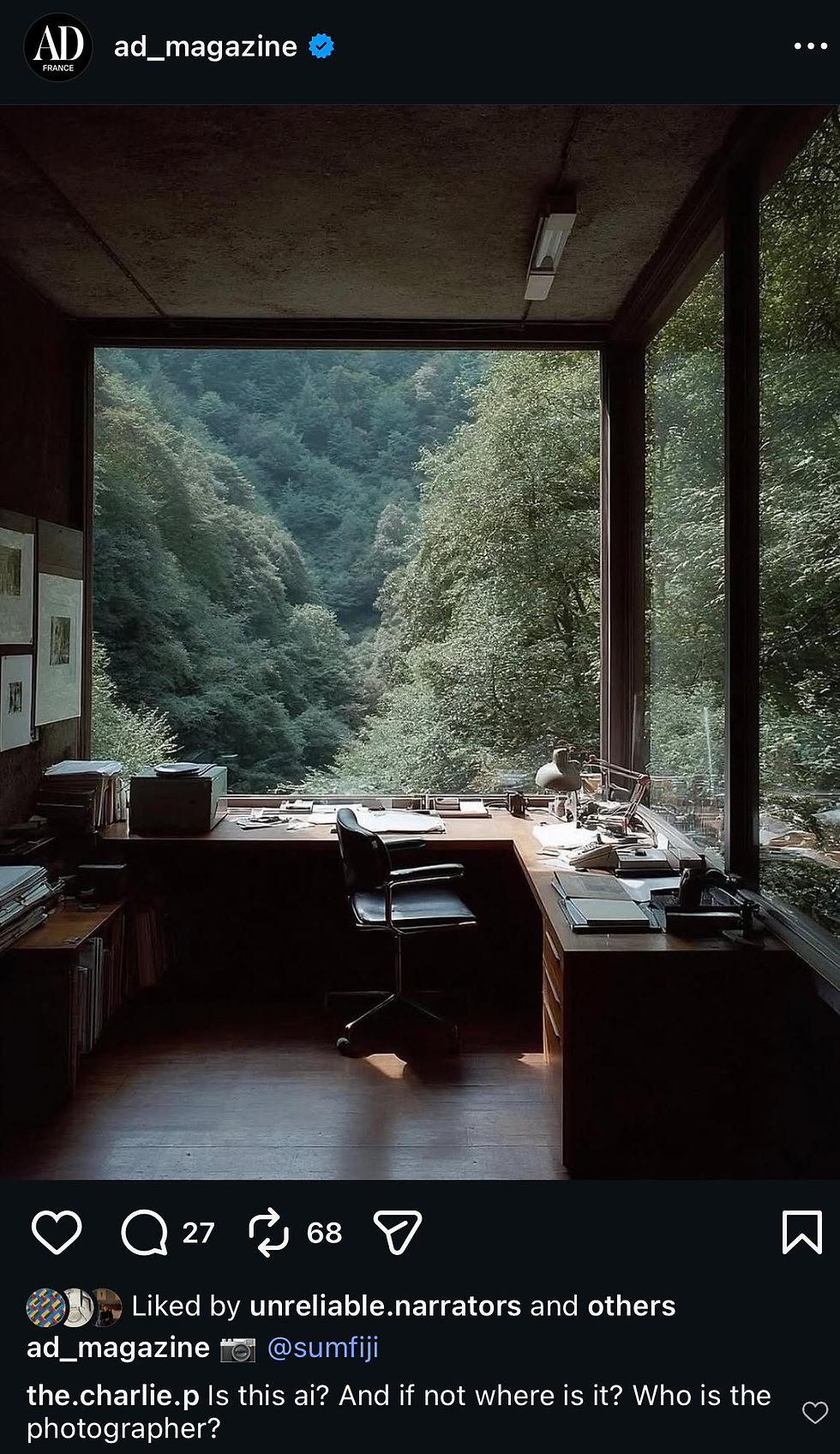 Office with desk, chair, and stacked papers, facing large window overlooking lush green forest. Calm and serene atmosphere.