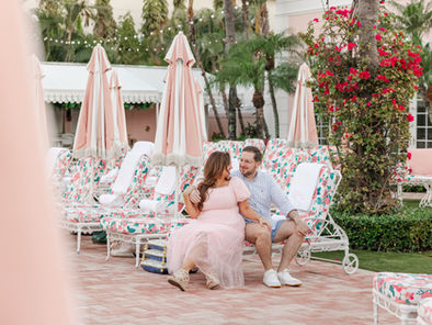 woman in pink dress sitting at the pink Colony Hotel