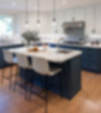 Modern California kitchen with natural light, white cabinetry, blue island, and marble countertops designed for everyday living.