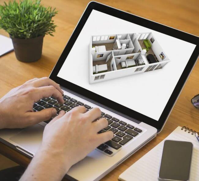 homem manuseando planta baixa nonotebook