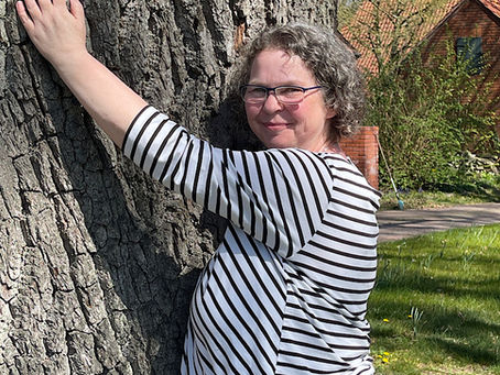 Beim Klangseminar umarmt Delia eine 200 Jahre alte Eiche
