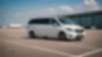 Wide angle view of a Mercedes V-Class parked at the airport terminal