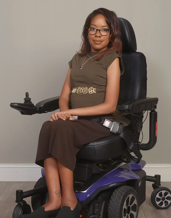 Charity posing for a picture in her wheelchair. 