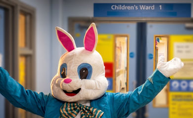 Bunny mascot in blue suit with bow tie in Children's Ward 1