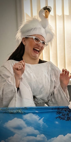 Laughing person in white swan hat