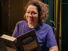 Smiling woman holding 'The Bedtime Classic' book