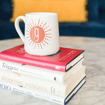 stack of books with mug on top