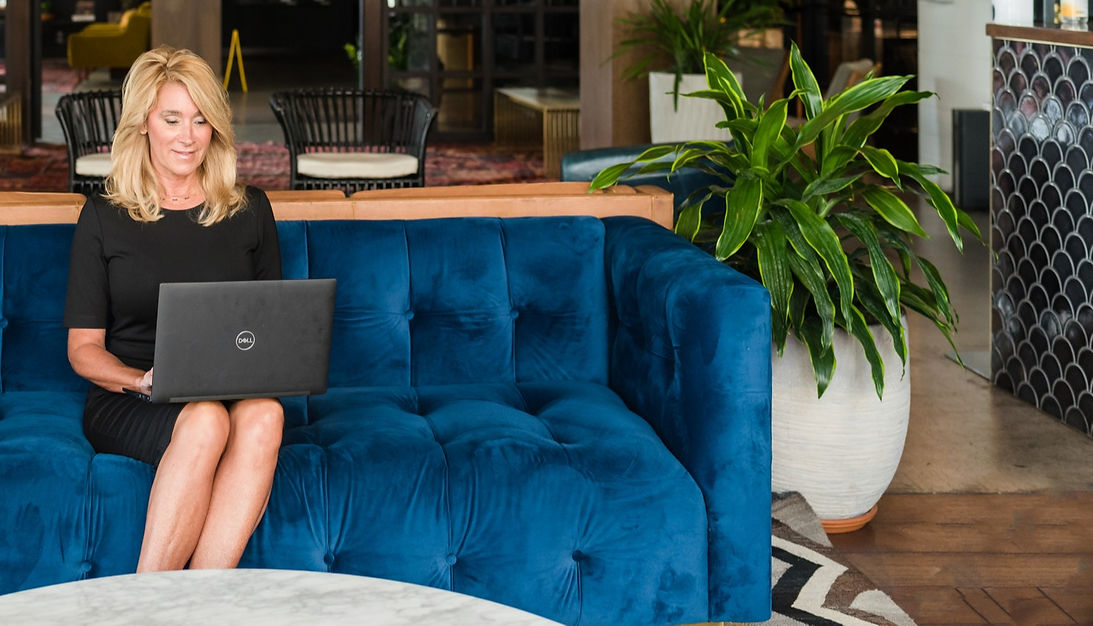 woman with laptop sitting on blue coach_edited.jpg