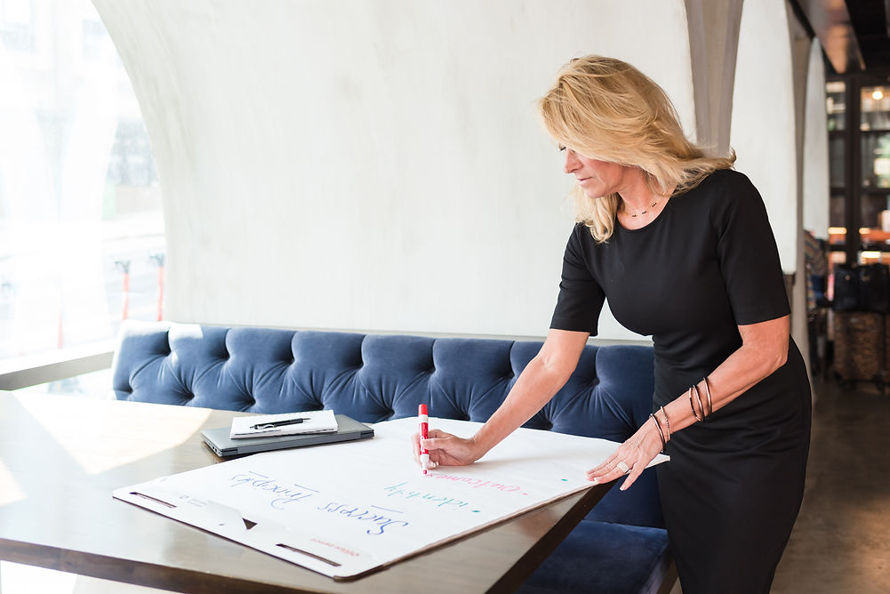 woman writing on poster