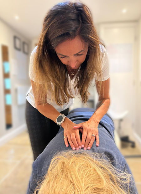 Dr Sophie assessing patients spine