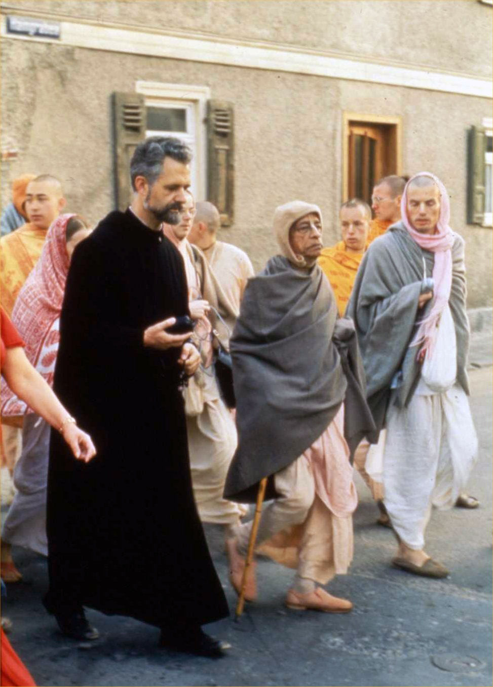 An Indian monk walks with his disciples