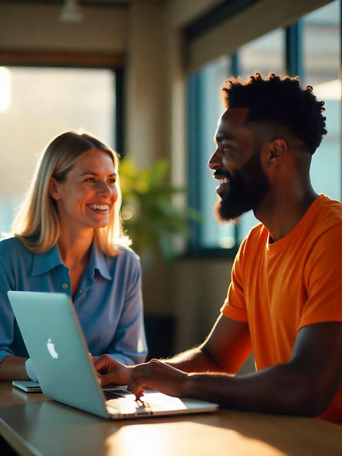 two happy office employees smiling whilst using a laptop. white woman and black man dressed well happy about the internet speeds