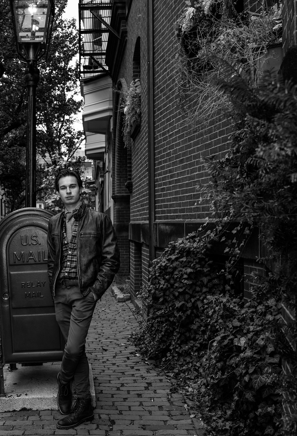 MAN STANDING NEXT TO VINTAGE MAILBOX IN BOSTON