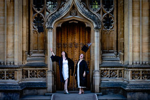 Oxford University graduate in academic dress posing in Radcliffe Square during a professional graduation photoshoot