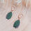 Miniature : Boucles d’oreilles pendantes en cuir vert de gris, modèle Loulous, monté sur des dormeuses dorées.