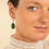 Miniature : Boucles d’oreilles pendantes en cuir vert de gris, modèle Loulous, monté sur des dormeuses dorées.