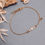 Miniature : Bracelet blanc et doré avec pierres naturelles et chaînette en acier inoxydable doré.