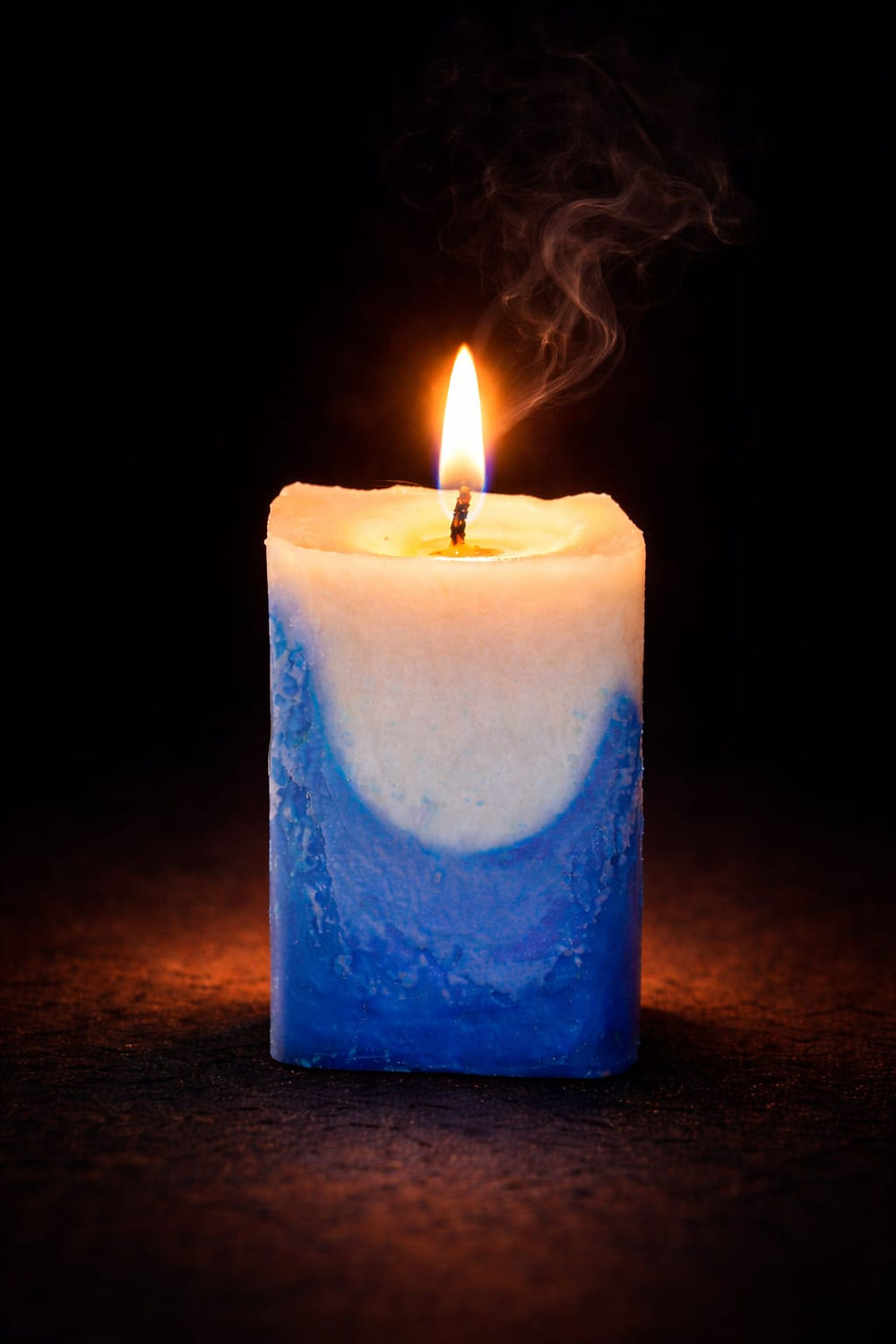 Luxury two-tone white and blue candle, lit