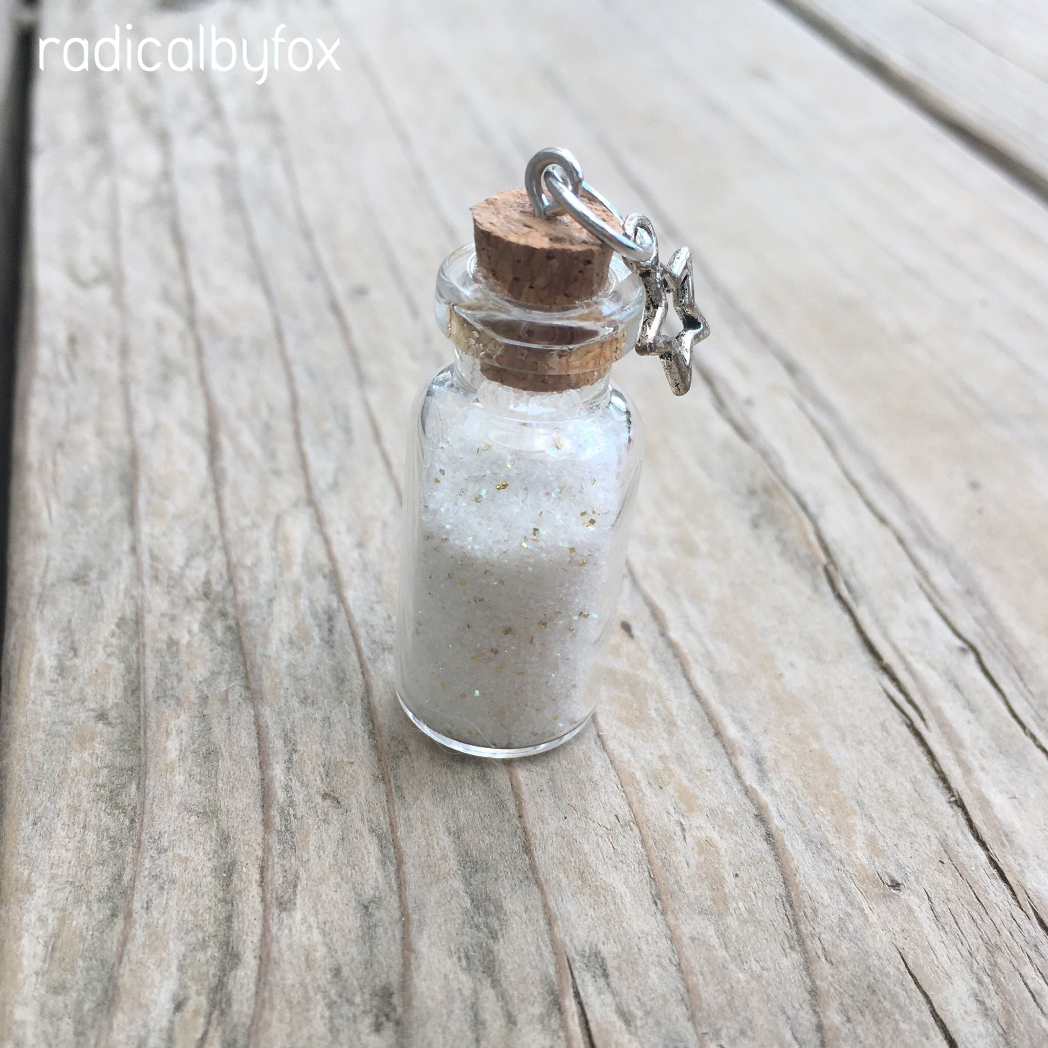 bottle filled with white and gold powder