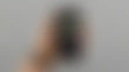 a hand is holding a cell phone with the anthony walsh podcast on it