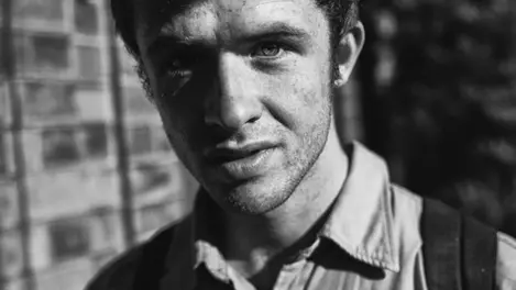 a black and white photo of a man 's face