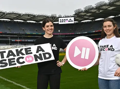 two women holding signs that say take a second
