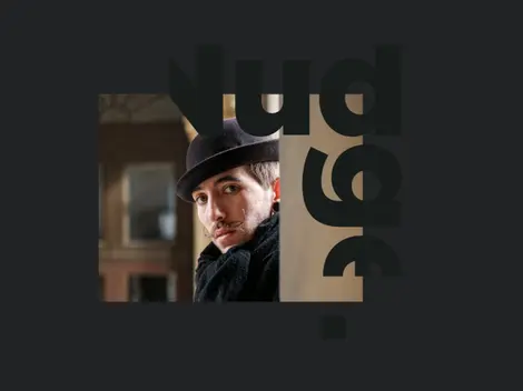 a man with a mustache wearing a black hat and a black scarf
