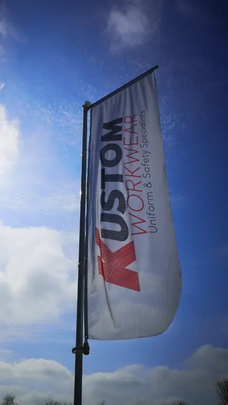 a flag that says custom workwear uniform & safety specialists