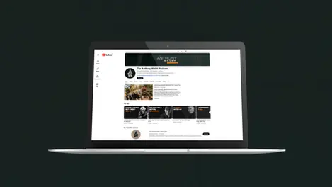 a laptop screen shows the anthony walsh podcast
