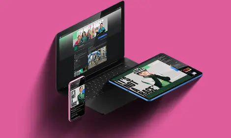 a laptop a phone and a tablet are displayed on a pink background