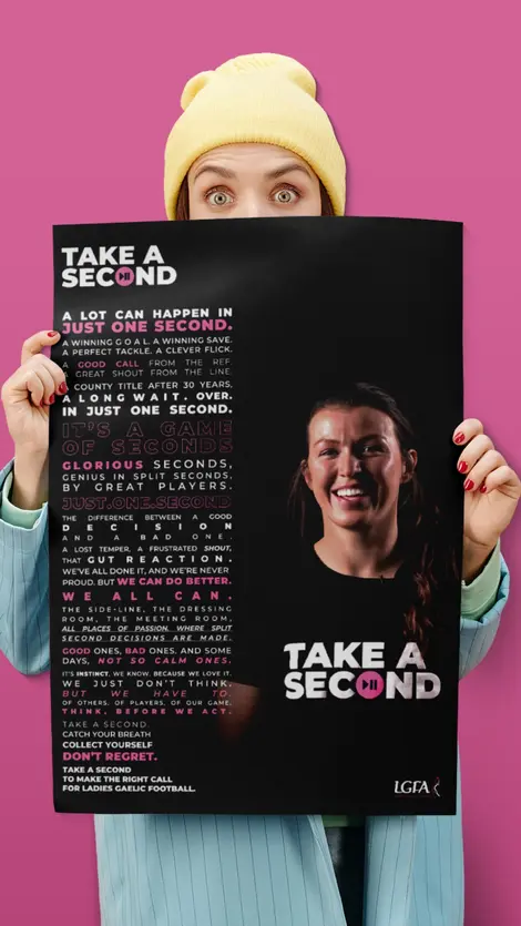 a woman is holding a poster that says take a second