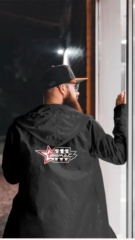 a man wearing a black jacket that says bigmac on the back