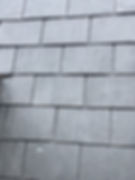A detailed texture shot of premium synthetic roofing shingles that mimic natural slate, highlighting lightweight and environmentally conscious residential roofing materials available through Central Roofing Inc. in San Francisco.
