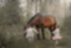 Little sisters walking with horse in a spring forest .jpg