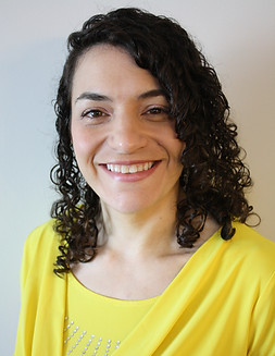 Carrie Headshot Yellow.JPG