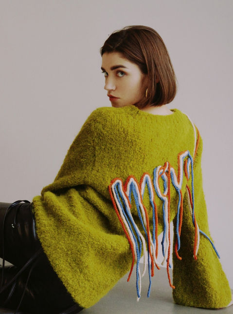 girl wearing a green sweater knit lab peru