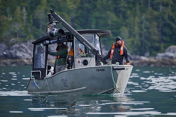 adventurous filmmakers on a boat with a Shotover