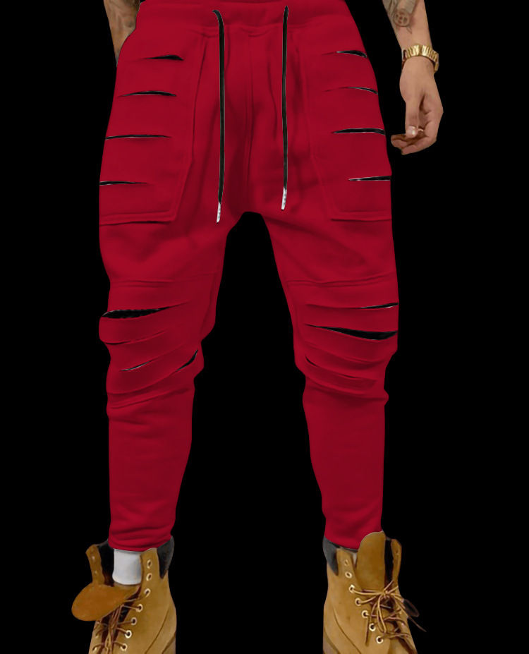 Thumbnail: A man wearing red ripped pants and tan boots, black background.