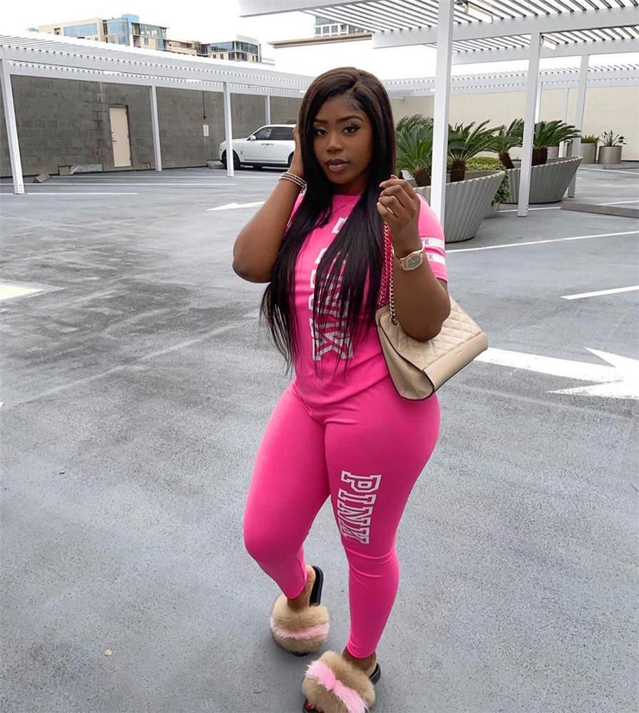 Thumbnail: Woman poses in pink Jogging Sweats Track Suit Sets Tracksuit Pink Sweatsuit for Women, bag, building.