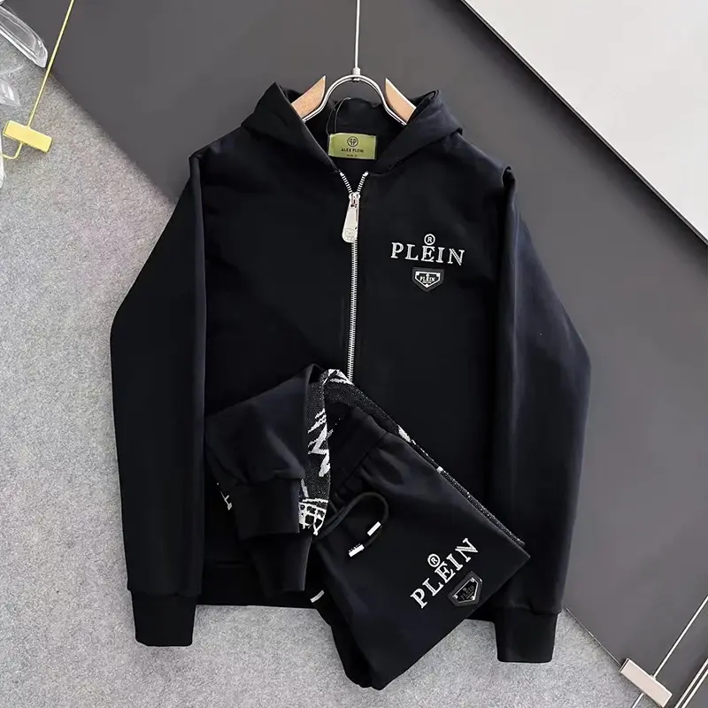 Black hoodie with PLEIN text logo, folded in front of the jacket.